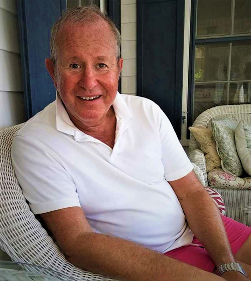 Ron Gold - sitting in chair at beach house