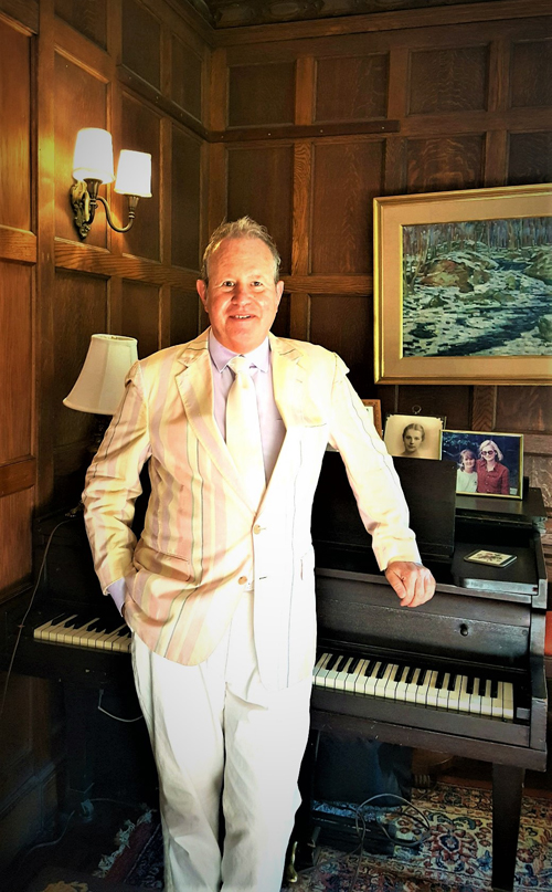 Ron Gold Standing upright by Grand Piano