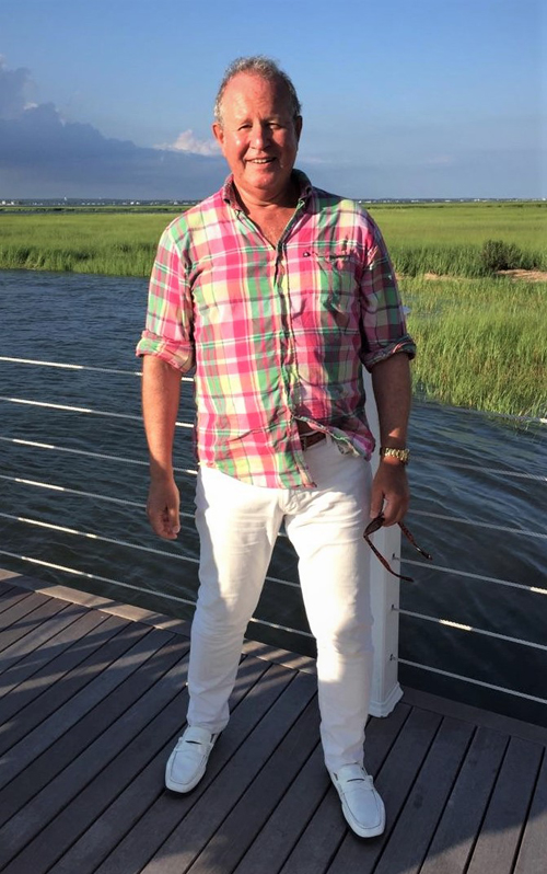 Ron Gold - standing on boardwalk at beach house